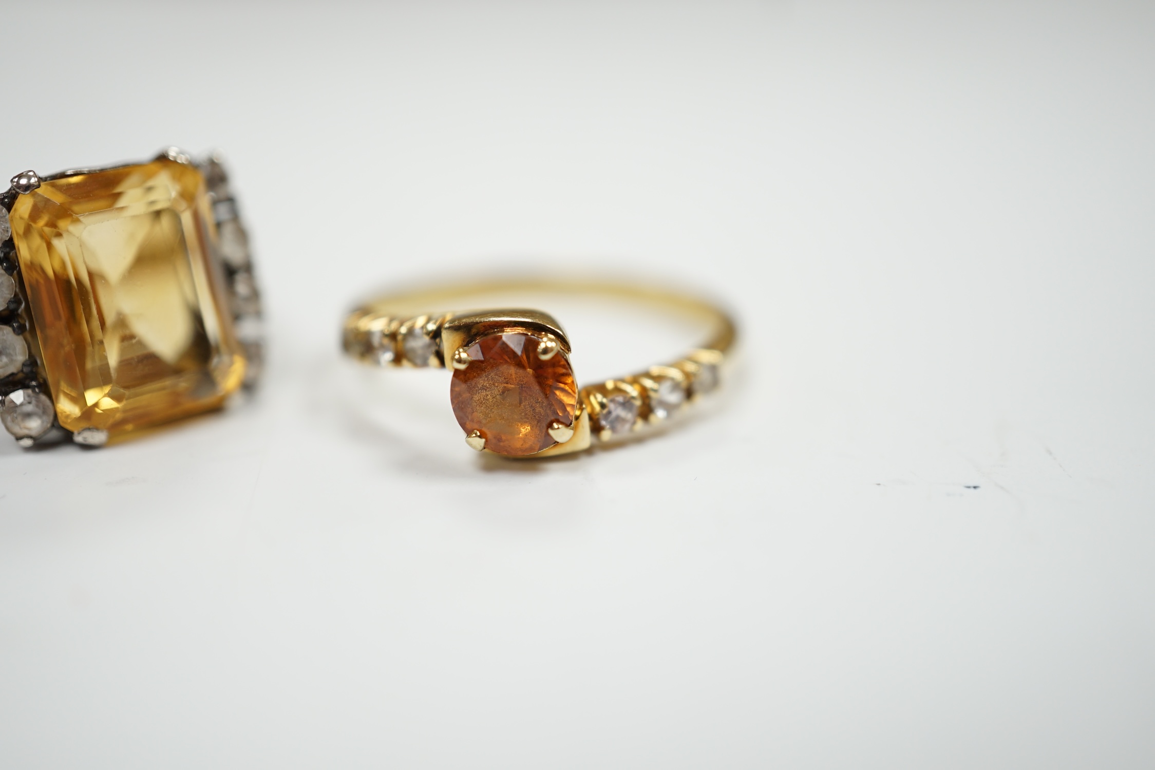 Two yellow metal citrine and simulated diamond set rings, gross weight 7.4 grams.